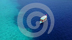 Luxury yacht cruising out at sea. Aerial view of luxury yacht cruising in turquoise lagoon. Aerial drone tracking video