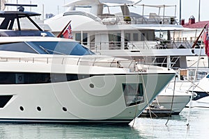 Luxury yacht docked in sea port. Marine parking of modern motor boats.