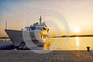 Luxury yacht on harbour at sunset