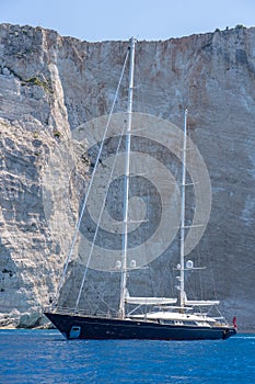 Luxury yacht parked in Ionian sea near shipwreck bay, Navagios beach in summer noon