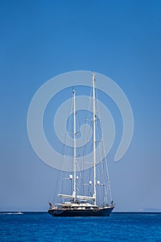 Luxury yacht parked in Ionian sea near shipwreck bay, Navagios beach in summer noon