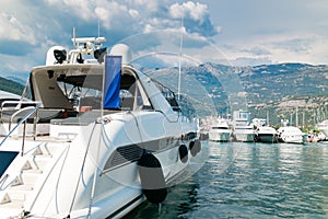 Luxury yacht ships at sea harbor near mountains landscape