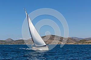 Luxury yacht with white sails in the Aegean sea