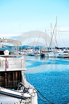 Luxury yachts docked in marina.