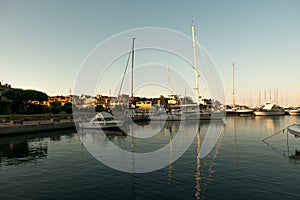 Luxury Yachts moored in a harbor of Porto Cervo on the early sunset, Sardinia, Italy