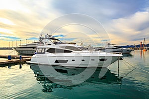 Luxury yachts moored at pier in sea port.