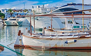 Luxury yachts and old fisher boats at port marina