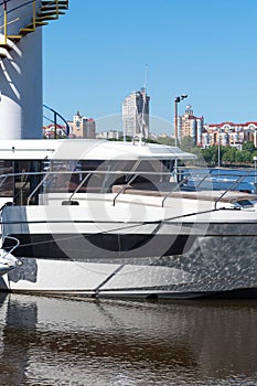 Luxury yachts in port. Details of boats on water, with reflection