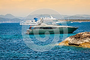 Luxury yachts in turquoise beach of Formentera Illetes