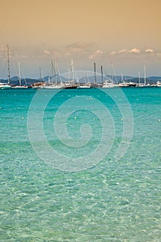 Luxury yachts in turquoise beach of Formentera Illetes