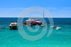 Luxury yachts in turquoise beach of Formentera Illetes