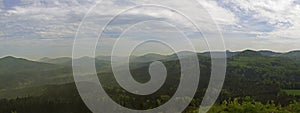 Luzicke hory mountains wide panorama, skyline view from hill stredni vrch, green forest and blue sky, white clouds background