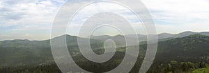 Luzicke hory mountains wide panorama, skyline view from hill stredni vrch, green forest and blue sky