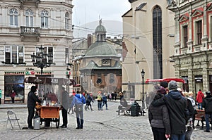 Lviv's main square, medieval architecture, tourists and townspeople