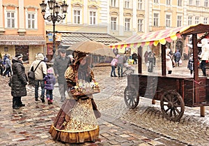 Lviv street, lovely girl sells candy