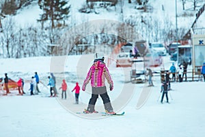 LVIV, UKRAINE - January 12, 2019: little boy skiing down hill