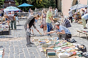 Lviv, Ukraine - July 2015: Men and women choose and buy, and sellers are selling old rare books and vintage items in the book mark