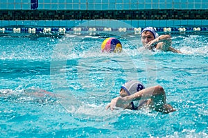 Lviv, Ukraine - July 2015: Ukrainian Cup water polo. Athlete team's water polo ball in a swimming pool and makes attacking shot on