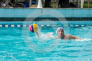 Lviv, Ukraine - July 2015: Ukrainian Cup water polo. Athlete team's water polo ball in a swimming pool and makes attacking shot on