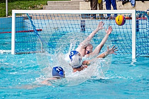 Lviv, Ukraine - July 2015: Ukrainian Cup water polo. Athlete team's water polo ball in a swimming pool and makes attacking shot on