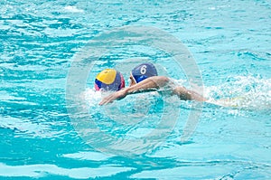 Lviv, Ukraine - July 2015: Ukrainian Cup water polo. Athlete team's water polo ball in a swimming pool and makes attacking shot on