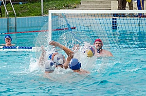 Lviv, Ukraine - July 2015: Ukrainian Cup water polo. Athlete team's water polo ball in a swimming pool and makes attacking shot on