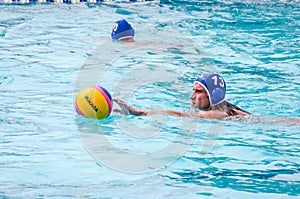 Lviv, Ukraine - July 2015: Ukrainian Cup water polo. Athlete team's water polo ball in a swimming pool and makes attacking shot on