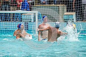 Lviv, Ukraine - July 2015: Ukrainian Cup water polo. Athlete team's water polo ball in a swimming pool and makes attacking shot on