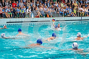 Lviv, Ukraine - July 2015: Ukrainian Cup water polo. Athlete team's water polo ball in a swimming pool and makes attacking shot on