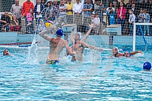 Lviv, Ukraine - July 2015: Ukrainian Cup water polo. Athlete team's water polo ball in a swimming pool and makes attacking shot on