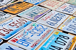Old discontinued car license plates or vehicle registration numbers from different USA states such as California