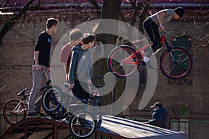 Lviv, Ukraine - March 12, 2020: BMX in the city skatepark. A group of teens on Bmx bikes in a skate park. Extreme sports