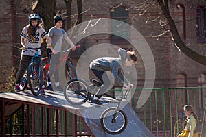 Lviv, Ukraine - March 12, 2020: BMX in the city skatepark. A group of teens on Bmx bikes in a skate park. Extreme sports