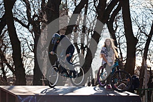 Lviv, Ukraine - March 12, 2020: BMX in the city skatepark. A group of teens on Bmx bikes in a skate park. Extreme sports