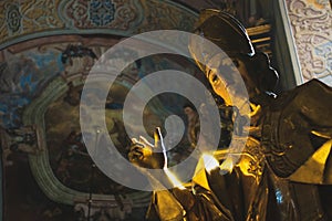 Lviv, Ukraine - May 9 2021:Blessing of a Catholic priest. Statue in the temple