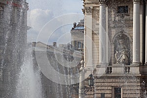 Lviv, Ukraine - Sept 09 2018: A fragment of the opera house in the rays of sunlight and splashes of a fountain. Romance and beauty