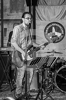 Lviv, Ukraine - September 2015: The musician plays guitar and sings in the Lviv CafÃÂ© before the audience fans