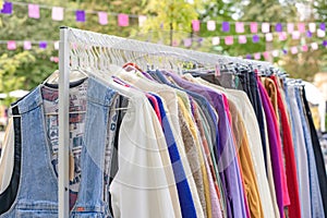 Lviv, Ukraine - September 29. 2022 : Vintage clothes for sale at flea market. Clothes on hangers - second hand clothes store photo