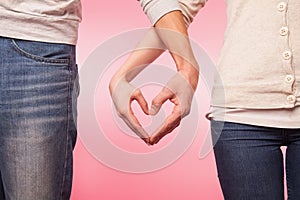 Lwoman and man hands showing heart shape