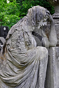 The Lychakiv cemetery in Lviv Ukraine. classic sculpture sad sorrowful woman at