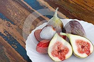 Lychee and figs on a wooden table
