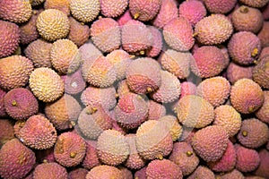 Lychee fruit yellow pink lilac in bulk. Fruits