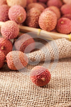 Lychee in the sharp foreground vertical