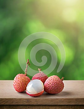 Lychee on wood with a blurred green background