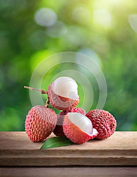 Lychee on wood with a blurred green background