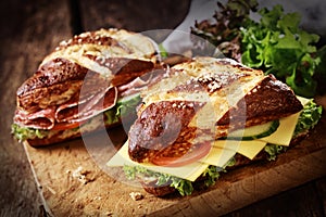 Lye bread rolls with cheese and salami photo
