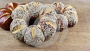 Lye kringle with sesame panning on a wooden board