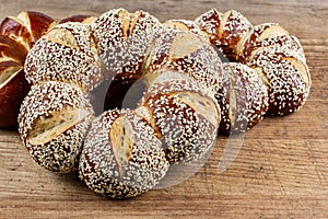 Lye kringle with sesame on a wooden board