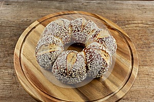 Lye kringle with sesame on a wooden board