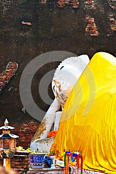 Lying Buddha dressed in yellow scarf in temple Wat Yai Chai-mongkol